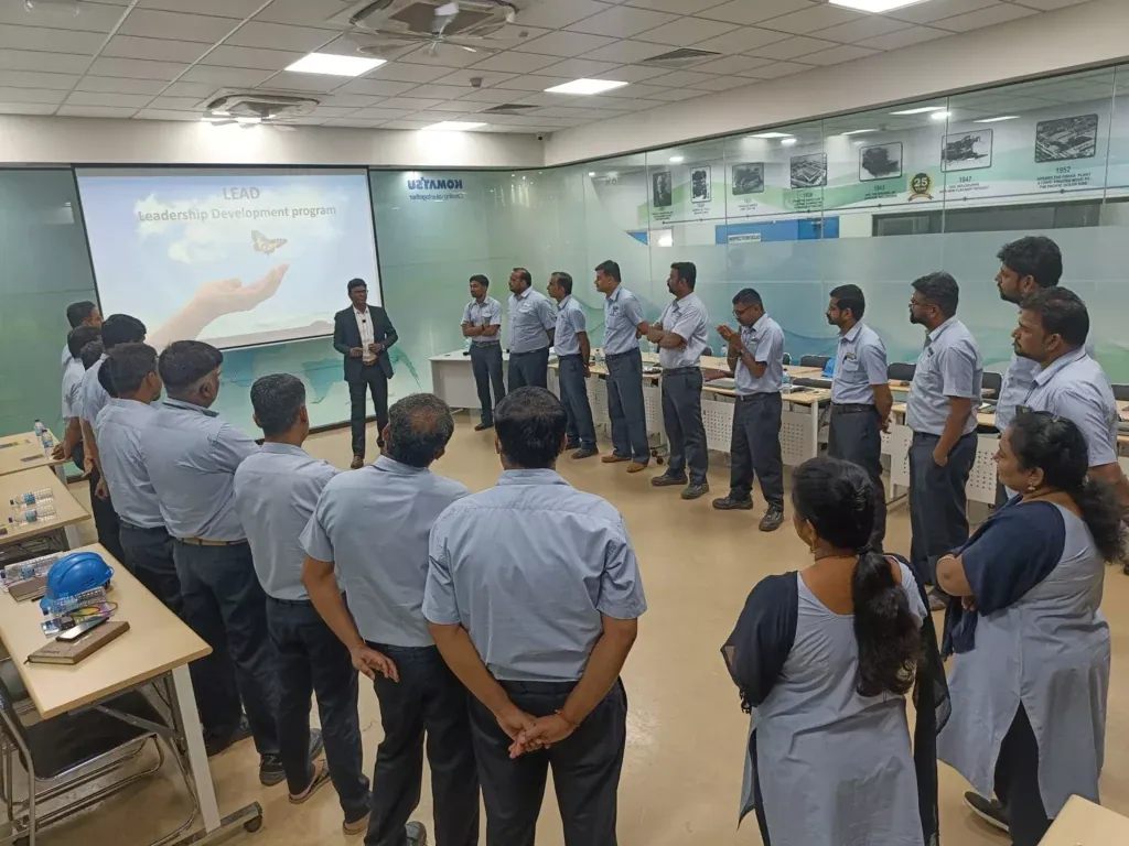 A facilitator leading a room of senior managers through a leadership session